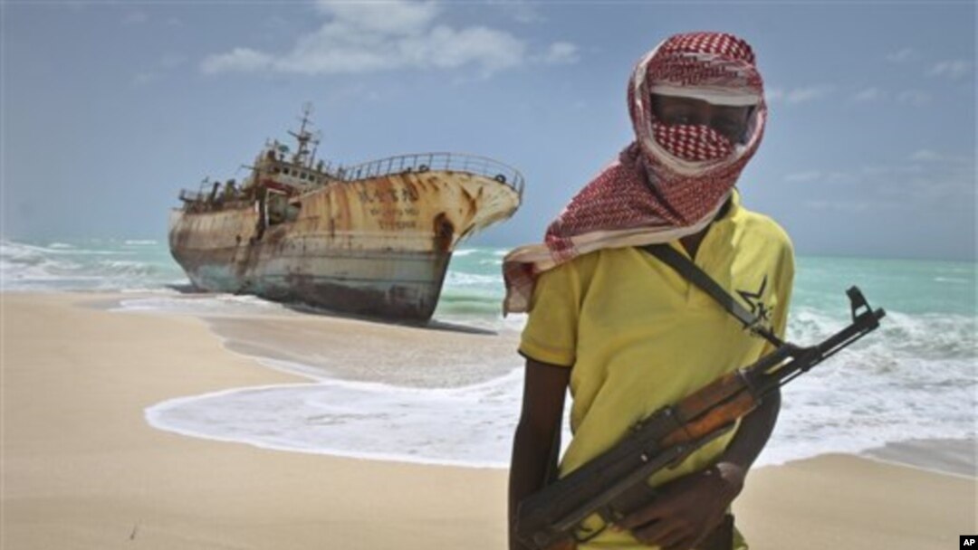 Um pirata somali vigiando um barco pesqueiro tailandês preso na regiao de Hobyo na Somália
