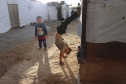 Syrian children play in Bekkaa Valley, Lebanon, Nov. 30, 2019. Right groups say the children are often not in school and are increasingly in danger of long-term statelessness. (Heather Murdock/VOA)