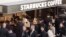 Customers line up at a Starbucks, April 2, 2015 in New York. 