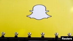 FILE - A billboard displays the logo of Snapchat above Times Square in New York.