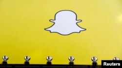 FILE - A billboard displays the logo of Snapchat above Times Square in New York.