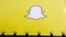 FILE - A billboard displays the logo of Snapchat above Times Square in New York.