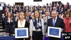 Venezuelan opposition presidential candidate Edmundo Gonzalez Urrutia and Ana Corina Sosa pose next to European Parliament President Roberta Metsola after during an award ceremony at in Strasbourg, Dec. 17, 2024.