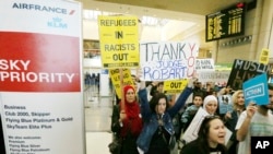 Demonstrators opposed to President Trump's travel ban march through Tom Bradley International Terminal at Los Angeles International Airport, Feb. 4, 2017. One sign thanks federal judge James L. Robart, who issued a stay of the order.