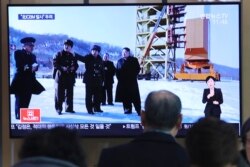 A man watches a TV screen showing a file image of the North Korean leader Kim Jong Un at his county long-range rocket launch site during a news program at the Seoul Railway Station in Seoul, South Korea, Monday, Dec. 9, 2019.