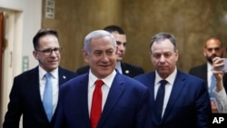 FILE - Israeli Prime Minister Benjamin Netanyahu arrives for his cabinet's weekly meeting, in Jerusalem, April 14, 2019. 