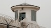 FILE - A guard stands in a watchtower in Kashgar, Xinjiang Uyghur Autonomous Region, China, May 3, 2021. 