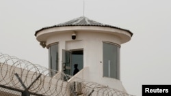 FILE - A guard stands in a watchtower in Kashgar, Xinjiang Uyghur Autonomous Region, China, May 3, 2021. 
