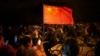 A cyclist waves a Chinese flag as thousands of college students ride on Zhengkai Road in Zhengzhou, in northern China's Henan province, Nov. 9, 2024.