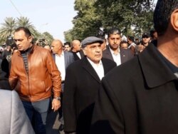 A picture by Iraq's Hashed al-Shaabi paramilitary force, Jan. 4, 2020, shows Iraq Prime Minister Adel Abdel Mahdi, center, arriving for the funeral of Iranian Gen. Qassem Soleimani and Iraqi paramilitary chief Abu Mahdi al-Muhandis in Baghdad.