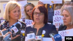 Shyhrete Tahiri-Sylejmani, center, speaks with the press, Oct. 14, 2019. At left, Feride Rushiti, of the Kosovo Rehabilitation Center for Torture, looks on.