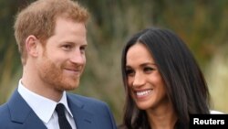 Britain's Prince Harry poses with Meghan Markle in the Sunken Garden of Kensington Palace, London, Britain, Nov. 27, 2017. 