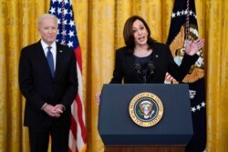 President Joe Biden listens as Vice President Kamala Harris speaks before signing the COVID-19 Hate Crimes Act, in the East Room of the White House, May 20, 2021, in Washington.