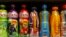 FILE - Soft drinks in bottles are displayed on a shelf in a shop in London, April 24, 2013. 