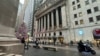 FILE - A scooter passes the New York Stock Exchange in New York's Financial District, Dec. 17, 2024. Stock prices fell Feb. 7, 2025, as investors fretted about inflation and tariffs.