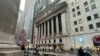 A scooter passes the New York Stock Exchange in New York's Financial District on Dec. 17, 2024.