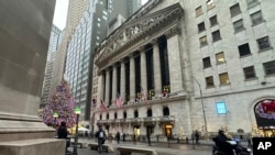 A scooter passes the New York Stock Exchange in New York's Financial District on Dec. 17, 2024.