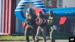 Terrorist Mounir el-Motassadeq is led from one helicopter to another at the airport in Hamburg, northern Germany, Monday, Oct. 15, 2018.