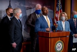 Sen. Tim Scott, center, accompanied by Sen. James Lankford, Senate Majority Leader Mitch McConnell of Ky., Sen. John Cornyn, Sen. Shelley Moore Capito, R-W.Va., and Sen. Lindsey Graham, speaks at a news conference on Capitol Hill, June 17, 2020.