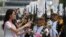 Cadet from the Korea Naval Academy reacts after receiving a garland from the winner of the 2013 Miss Korea Pageant during a parade to mark the 65th anniversary of Korea Armed Forces Day in central Seoul, South Korea. 