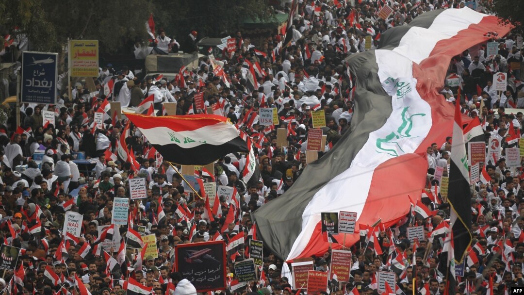 Thousands of Iraqis, waving national flags, take to the streets in central Baghdad on January 24, 2020 to demand the ouster of US troops from the country.