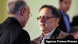 FILE - Then-head of the Central Bank of Iran, Valliollah Seif (R), speaks to Iran's head of its Atomic Energy Organisation Ali Akbar Salehi, in Tehran, Iran Jan. 17, 2016. 