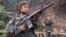 FILE - Two child soldiers prepare to fight against Myanmar's military government in a jungle camp near the border with Thailand, Jan. 31, 2000. One expert told the U.N. Security Council on Tuesday that armed groups around the world are using children to build their ranks.