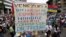 FILE - Opposition supporters rally against President Nicolas Maduro carrying a sign that reads "Venezuela is wounded in the heart with hunger, misery, corruption and dictatorship," in Caracas, Venezuela, May 10, 2017.