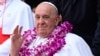 Pope Francis wears a flower garland as he arrives for an interreligious meeting with young people at the Catholic Junior College in Singapore on Sept. 13, 2024. 