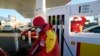 Lebohang, a fuel attendant fills up a vehicle in Soweto, South Africa, Tuesday, May 31, 2022. (AP Photo/Themba Hadebe)