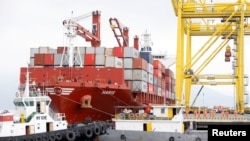 Containers are loaded onto a ship at Tien Sa port in Da Nang, Vietnam, March 6, 2020. 