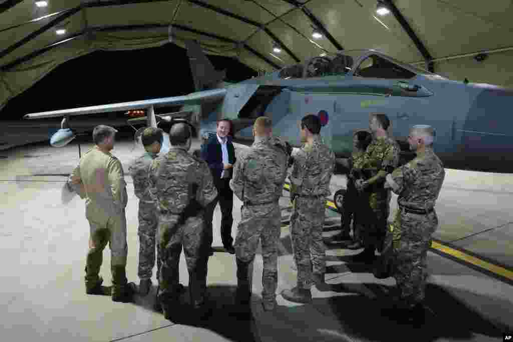 British Prime Minister David Cameron meets pilots, engineers and logistic support staff in front of a Tornado GR4 at RAF Akrotiri base, Cyprus, Oct. 2, 2014.