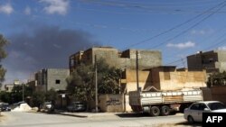 FILE - Smoke rises following an air strike in Libya's eastern coastal city of Benghazi, Sept. 1, 2014. 