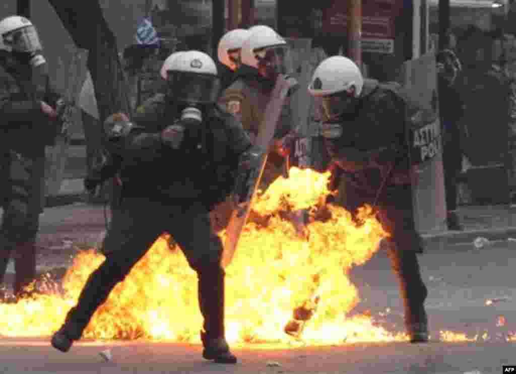 A petrol bomb explodes among riot police during clashes with protesters in Athens, Wednesday, Dec. 15, 2010. Some hundreds of protesters clashed with riot police across central Athens Wednesday, smashing cars and hurling gasoline bombs during a massive la