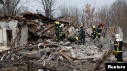 Rescuers work at a site of a residential house damaged during a Russian missile strike, amid Russia's attack on Ukraine, in Kyiv, Ukraine Dec. 29, 2022. 