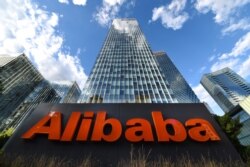 FILE - The company sign of Alibaba Group Holding Ltd is seen outside its headquarters in Beijing, China, June 29, 2019.