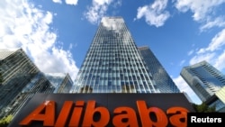 FILE - The company sign of Alibaba Group Holding Ltd. is seen outside its headquarters in Beijing, China, June 29, 2019.