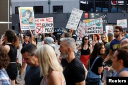 FILE - Anti-vaccine protesters confront people as they queue to enter a concert which requires proof of vaccination to enter, at the Madison Square Garden, in New York City, June 20, 2021.