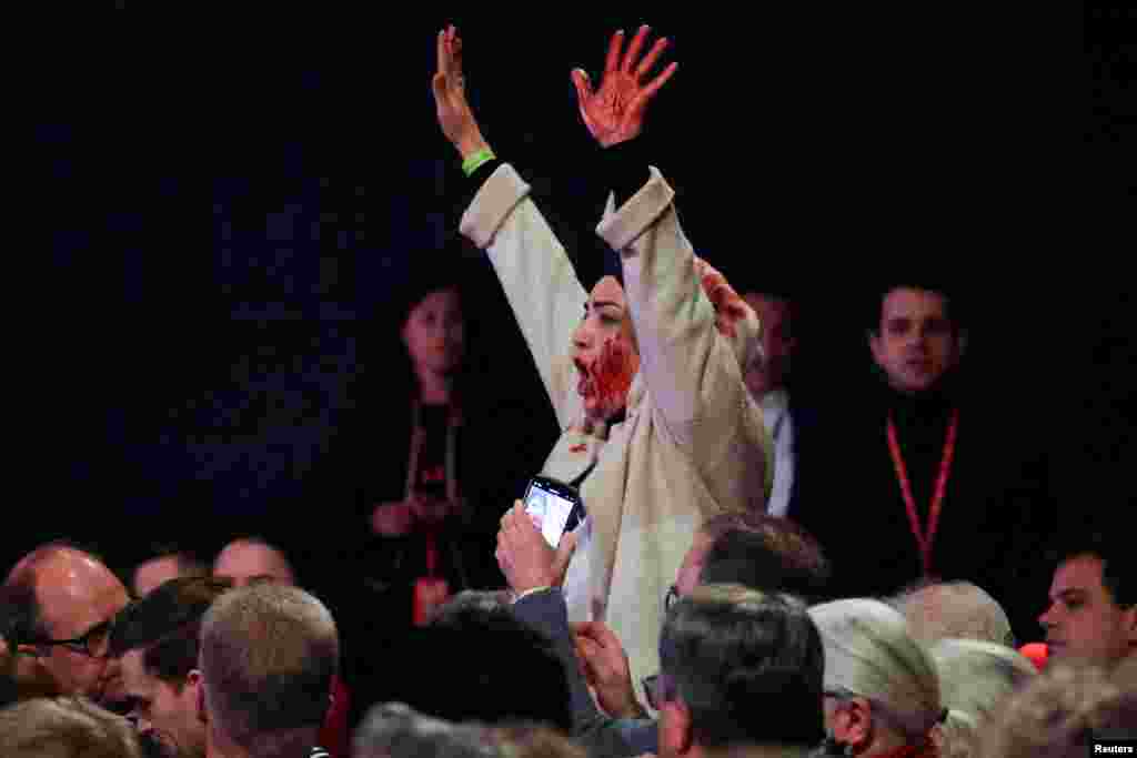 A protester shouts &quot;Free Palestine,&quot; as German Chancellor Olaf Scholz visits a former locomotive shed and meets local citizens during the start of his Social Democratic (SPD) party election campaign tour, in Bielefeld.