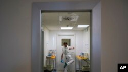 A doctor disinfects his shoes as he leaves the ICU unit of Rome's San Filippo Neri Hospital's Covid department, in Rome, April 9, 2020.