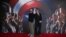 Chris Evans, left, and Robert Downey Jr. pose for photographers at the photo call of the film "Captain America Civil War" in London, April 25, 2016.