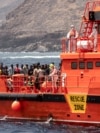 FILE - Migrants disembark at the port of on 'La Estaca' in Valverde at the Canary island of El Hierro, Spain, Aug. 26, 2024. Rescue teams on Sunday resumed searching for at least 48 migrants who went messing the day before when their boat overturned.