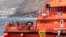 FILE - Migrants disembark at the port of on 'La Estaca' in Valverde at the Canary island of El Hierro, Spain, Aug. 26, 2024. Rescue teams on Sunday resumed searching for at least 48 migrants who went messing the day before when their boat overturned.