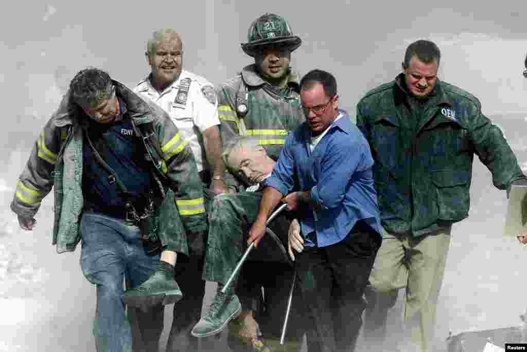 Rescue workers carry fatally injured New York City Fire Depatment Chaplain, Fether Mychal Judge, from one of the World Trade Center towers.