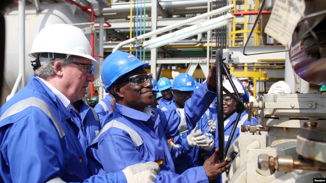 FILE - Ghana's President John Atta Mills turns on the valve to allow the first barrel of crude to flow from the Jubilee offshore oil field.