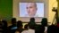 FILE - Journalists look a image of Indian naval officer Kulbhushan Jadhav, arrested in March 2016, during a press conference by Pakistan's army spokesman and the Information Minister, in Islamabad, Pakistan. 