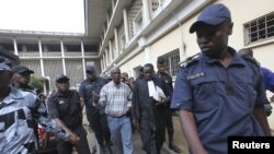 Laurent Akoun, center, a top FPI official, after his trial at a court in Abidjan, August 31, 2012.