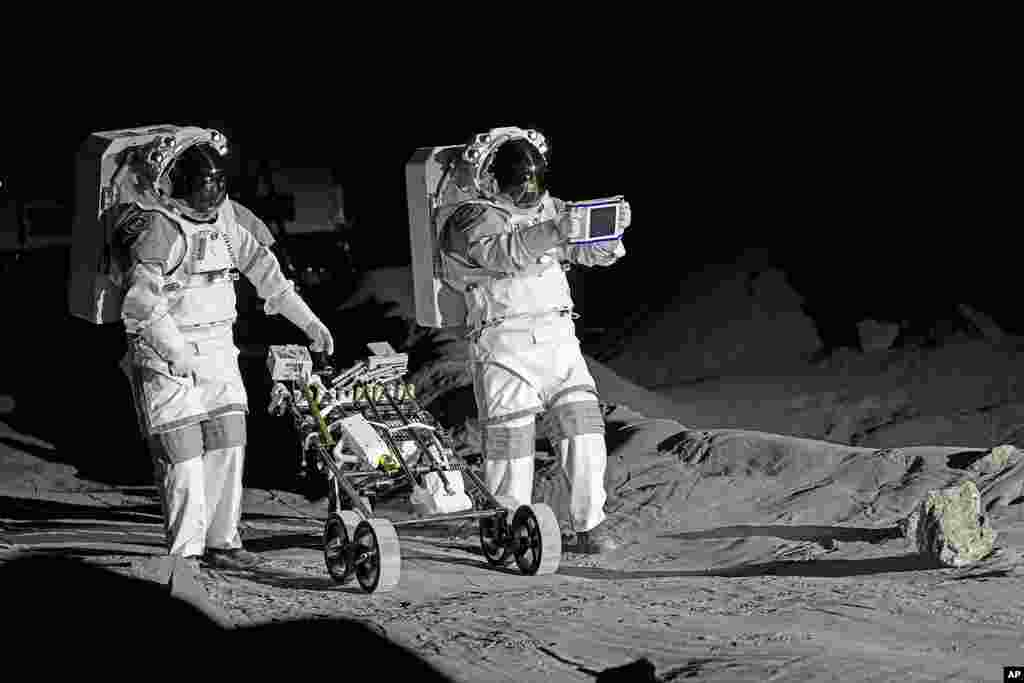 Astronauts Thomas Pesquet of France and Matthias Maurer of Germany demonstrate their training in lunar surface simulating conditions, at the opening of the new LUNA facility at the European Astronaut Center in Cologne, Germany.