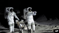 Astronauts Thomas Pesquet of France and Matthias Maurer of Germany demonstrate their training in lunar surface simulating conditions, at the opening of the new LUNA facility at the European Astronaut Center in Cologne, Germany.