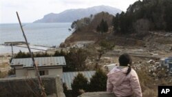 Manami Kon, 4, waits for her parents and younger sister who are still missing after the March 11 massive earthquake and tsunami, in Miyako, northern Japan, March 22, 2011